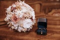 Dark blue wedding box with wedding rings inside on white marble stone. Wedding bouquet of dried flowers. Holiday concept Royalty Free Stock Photo