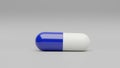 One dark blue white capsule pill on a white background - Medicine healthcare medicaments