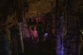 Dark blurred multicolored abstract background of stalactites, stalagmites and stalagnates in Sfendoni cave, underground,