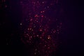 Dark bokeh background of small purple festive glitter lights Royalty Free Stock Photo