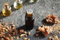 A dark bottle of essential oil with myrrh resin Royalty Free Stock Photo