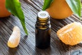 A dark bottle of tangerine essential oil on a wooden table Royalty Free Stock Photo