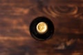 A dark bottle of wine blurry on a wooden background