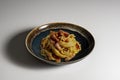 Dark bowl with spaghetti carbonara on white background Royalty Free Stock Photo