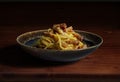 Dark bowl with spaghetti carbonara on wooden table Royalty Free Stock Photo