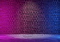 Dark brick wall corridor with blue and pink lighting, spot light in the middle Royalty Free Stock Photo