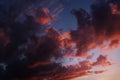 Dark bright pink and purple clouds in blue sky