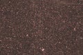 Dark brown asphalt road texture. Abstract background of small pebbles, road surface. Brown pattern of granite stone. Art design, t Royalty Free Stock Photo