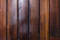 Dark brown boards background with spots. Old wet wood texture pattern after rain with reflections Royalty Free Stock Photo