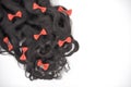 Dark brown curly hair with red bowknots on the white background Royalty Free Stock Photo