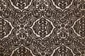 Dark brown flock wallpaper pattern