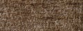 Dark brown fluffy background of soft, fleecy cloth. Texture of umber textile fabric backdrop