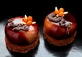 Dark brown glazed desserts with fresh buckthorn berries and almonds on brownie base