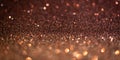 Dark brown glitter lights. Shiny sparkles, bokeh effects, glowing surface. Selective focus, christmas abstract banner Royalty Free Stock Photo