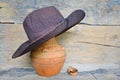 Dark brown hat on old baked clay jar Royalty Free Stock Photo