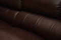 Dark Brown leather sofa, close up detail. Furniture showroom photography Royalty Free Stock Photo