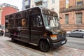 Dark brown Mercedes-Benz van of the shipping service UPS which delivers packages all around the world in the streets of Scottish