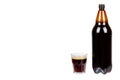 Dark brown plastic bottle of beer or kvass with glass cup isolated on a white background, copy space template. Royalty Free Stock Photo