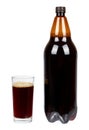 Dark brown plastic bottle of beer or kvass with glass cup isolated on a white background. Royalty Free Stock Photo