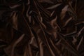 Dark brown silk satin fabric background. Delicate wavy folds. Abstract textile texture. Copy space for your design. Royalty Free Stock Photo