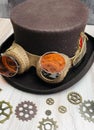 dark brown steampunk top hat with goggles, shades, feather, and gears (grooms hat)