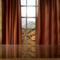 A brown table with blurred mountains and blue cloudy sky background behind the window. Royalty Free Stock Photo