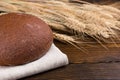 Dark brown wholewheat bread loaf with wheat