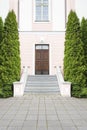 Dark brown wood door, stairway and trees