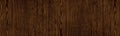 Dark brown wood grain wide panoramic texture. Natural larch plywood large backdrop. Wooden surface rustic banner Royalty Free Stock Photo