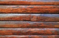 Dark brown wood log wall of an aging log cabin for texture, background