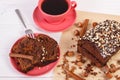 Dark cake with chocolate, cocoa and plum jam, cup of coffee, delicious dessert Royalty Free Stock Photo