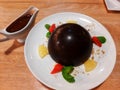 Dark chocolate ball on a plate - image