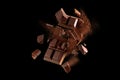 Dark chocolate bar breaking apart in mid air Royalty Free Stock Photo