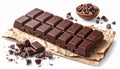 Dark Chocolate Bar on Brown Paper with Chocolate Pieces and Isolated White Background Royalty Free Stock Photo
