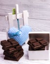 Dark chocolate bars on grey wooden background