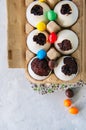 Dark chocolate brownie dessert in egg shells. Easter or funny kids party concept. White stone background.