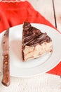 Dark chocolate cake with Coffee slice with chocolate buttercream frosting on a white plate.Selective focus.Copy space