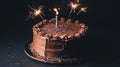 Dark chocolate cake, sparklers, celebration, studio Royalty Free Stock Photo
