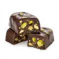 A dark chocolate candy with visible pistachio pieces inside, with a shiny outer shell and detailed