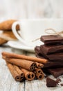 Dark chocolate , cinnamon sticks and a cup of coffee