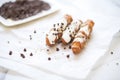 dark chocolate-dipped cannoli on white parchment