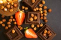 Dark chocolate, fresh strawberries, almond antioxidant assortment flavor nuts on a dark background