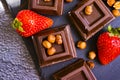 Dark chocolate, fresh strawberries, confection antioxidant assortment flavor nuts on a dark background