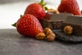 Dark chocolate, fresh strawberries, sweet antioxidant assortment flavor nuts on a dark background