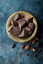 Dark chocolate pieces crushed and cocoa beans, culinary background Royalty Free Stock Photo