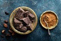 Dark chocolate pieces crushed and cocoa beans, culinary background Royalty Free Stock Photo