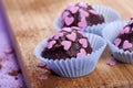 Dark chocolate pralines with pink hearts Royalty Free Stock Photo