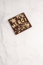 Dark chocolate square with white chocolate thank you note