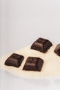 Dark chocolate squares and raw sugar cane Royalty Free Stock Photo