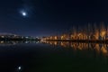 Dark city landscape of lake and moon Royalty Free Stock Photo